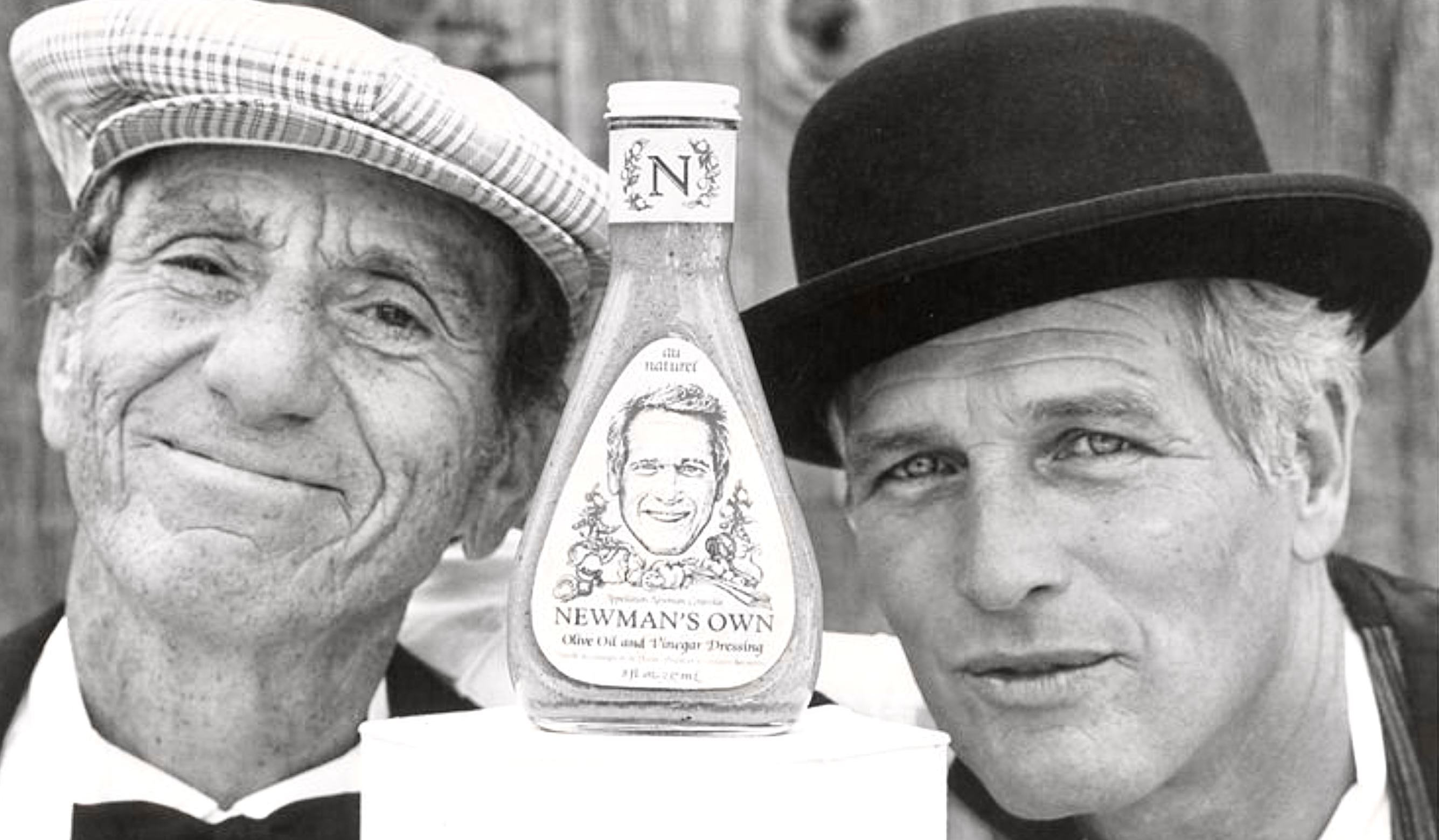 A.E. Hotchner on the left, Paul Neman on the right, and a bottle of salad dressing in between.
